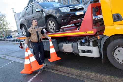a tow truck takes away a broken car a tow truck takes away a broken car