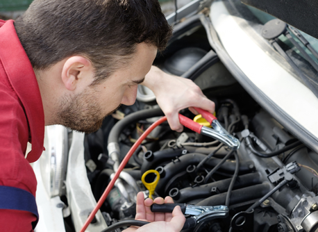 mechanic working on car engine with electricity cables mechanic working on car engine with electricity cables